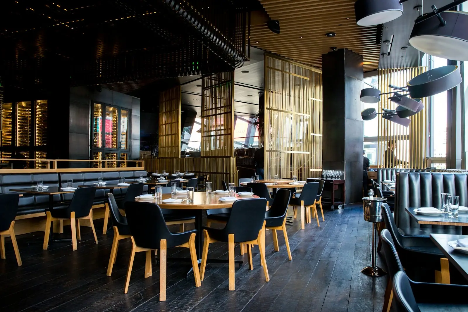 Tables set for evening service in a modern restaurant dining room
